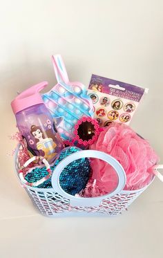 a basket filled with lots of toys and items on top of a white countertop