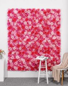 a pink flowered wall hanging in front of a chair