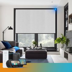 a living room filled with furniture and a large window covered in white roller shade shades