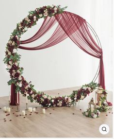 a wedding arch decorated with flowers and candles