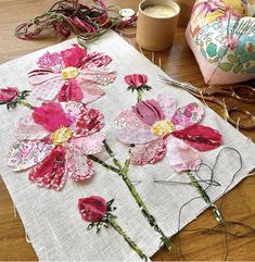 the flowers are being sewn together on the table