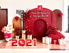 a red and white display with presents on the floor in front of a sign that says happy new year