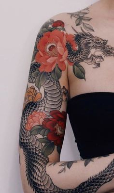 a woman with tattoos on her arms and arm