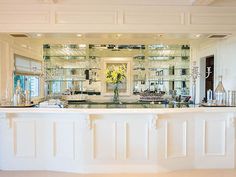 a large kitchen with white cabinets and counter tops