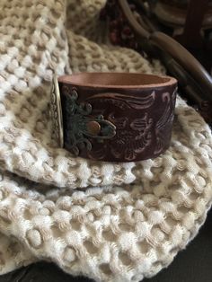 "🔸🔸orders are delayed by a few days this week. Thank you for your patience Country leather bracelet cuff, western jewelry Embossed distressed genuine brown leather 1 1/2\" strap has been adorned with an oval southwestern silver concho which sets on a detailed antiqued copper filigree which has been given a rich patina. It is attached to the leather with two antiqued copper rivets. One antiqued copper snap has been placed to fit up to a 7 1/4\" wrist. I can add another snap if you would like a Brown Concho Jewelry For Rodeo, Brown Hand Tooled Jewelry For Rodeo, Hand Tooled Brown Jewelry For Rodeo, Brown Bohemian Leather Bracelet With Concho, Western Brown Hand-tooled Jewelry, Western Leather Jewelry With Concho, Vintage Brown Jewelry For Rodeo, Vintage Leather Bracelet With Concho, Southwestern Adjustable Brown Leather Bracelet