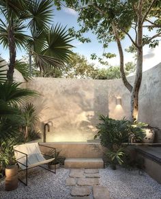 an outdoor bathroom with stone steps leading up to the bathtub and trees in the background