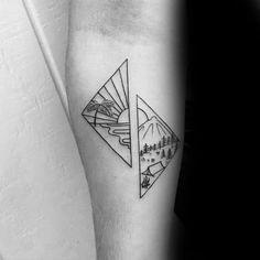 a black and white photo of a mountain landscape tattoo on the left inner half arm