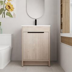 a white toilet sitting next to a wooden cabinet in a bathroom with sunflowers on the wall