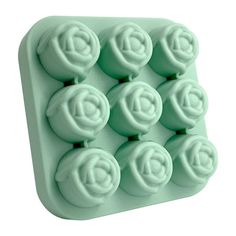 an ice tray that has eight balls in the shape of a letter on top of it