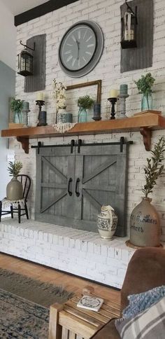 a living room filled with furniture and a clock on top of a fireplace mantel