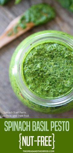 spinach basil pest in a jar on a wooden table with spoons and parsley