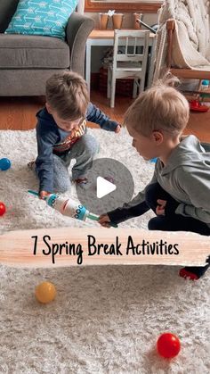 two young boys playing with toys on the floor