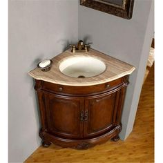 a bathroom with a sink and mirror on the wall next to wood floored floors