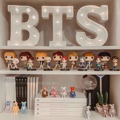 a shelf filled with lots of little figurines on top of it's shelves