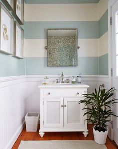 a bathroom with blue and white striped walls