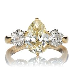 an engagement ring with three pear shaped diamonds