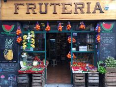 a fruit stand with lots of fruits and vegetables