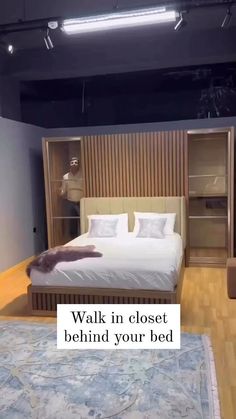 a bed sitting in the middle of a bedroom next to a book shelf with a stuffed animal on top of it