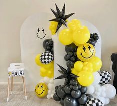 balloons are arranged in the shape of smiley faces and checkered black and white squares