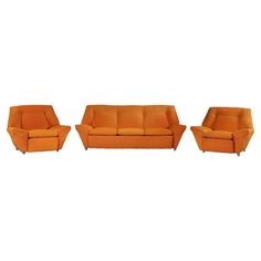 three orange couches and two chairs on a white background with one chair facing the camera