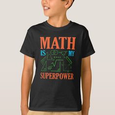 a young boy wearing a black t - shirt that says math is my super power