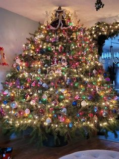 a decorated christmas tree in a living room with lights and ornaments on the bottom half