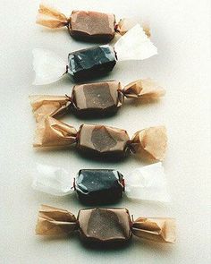 three pieces of chocolate sitting on top of each other in cellophane wrappers