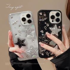 two women holding up their iphone cases with glitter stars on the back, and one wearing black