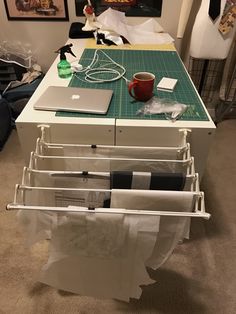 a laptop computer sitting on top of a table next to a pile of paper towels