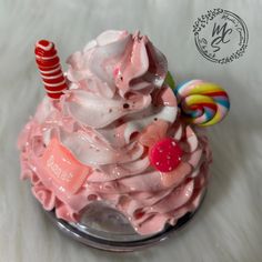 a cupcake with pink frosting and candy on top