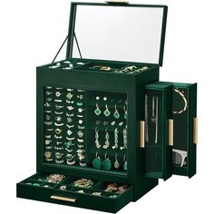 an open green jewelry box filled with lots of earrings