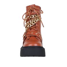 Let's bring rock n' roll vibe back with EMELIE. Bold chain with buckle punctuates this lug sole boot with stylish feel to bring out your edgy appeal. Wear them with cropped jeans, skirts, or tights. Vegan leather upper with man made sole Side zipper closure Heel measures approx. 2.5" H Platform measures approx. 1.5" H Imported Punk Lace-up Boots With Lug Sole For Fall, Fall Platform Boots With Grommets And Round Toe, Trendy Chain Boots For Fall, Edgy Chain Boots For Streetwear, Punk Style Chain Boots For Streetwear, Trendy Brown Moto Boots With Lug Sole, Edgy Chain Boots With Round Toe, Edgy Fall Boots With Grommets, Edgy Boots With Chain And Round Toe