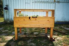 a wooden box with plants growing in it