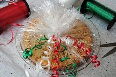 a table with some scissors and spools of thread next to a plate filled with cookies