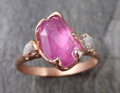 Partially faceted (by my husband) pink sapphire with raw conflict-free diamonds on each side. Wonderful natural inclusions. I hand carved this ring in wax and cast it in recycled solid 14k rose gold using the lost wax casting process. This one of a kind raw gemstone ring is a size 7 it can be resized up or down for you as needed. The sapphire stone measures about 9.5mm X 7mm. The rough diamonds are about 3mm. Throughout all time and history in every tribe and culture all around the world crystal Raw Gemstone Ring, Wedding Rings Solitaire, Wax Casting, Purple Band, Fancy Diamonds, Rose Gold Engagement, Minerals And Gemstones, Gold Engagement Ring, Sapphire Stone