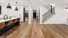 an open floor plan with white walls and wood floors