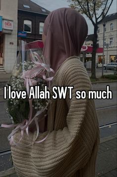 a person with a hood on holding flowers in front of the camera and text that reads, i love allah swt so much