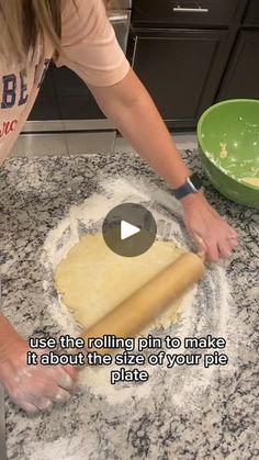 a woman rolling dough on top of a kitchen counter