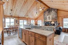 a kitchen and living room in a log cabin