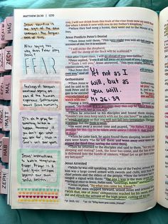 an open bible with sticky notes attached to the pages and colored writing on each page