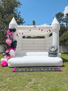 an inflatable bed with balloons on the lawn