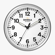 a close up of a clock on a white background with the words shinola detroit