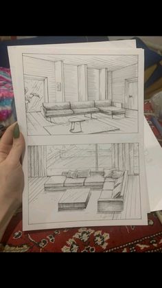 a person holding up some paper with drawings on it in front of a couch and coffee table