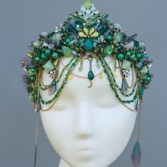 Enchanted Green Moonstone Tiara, a mesmerizing blend of emerald crystals, moonstones, and delicate beadwork, perfect for those who love fantasy and nature-inspired accessories.  This handmade crown features intricate wirework adorned with shimmering green beads, opalescent moonstones, and dainty chains, creating a whimsical and ethereal look. Ideal for weddings, cosplay, festivals, or bohemian-themed events, this tiara captures the essence of a mermaid queen or forest fairy. With its adjustable fit and comfortable design, it's the ultimate statement piece for your magical moments. Perfect for brides, cosplayers, or anyone seeking a unique touch of enchantment! Moonstone Tiara, Fantasy Headband, Forest Crown, Mermaid Headpiece, Mermaid Crowns, Crown Fairy, Mermaid Queen, Fairy Headpiece, Crowns And Tiaras