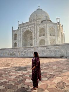 a woman standing in front of the tajwa