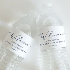 two water bottles with labels on them sitting next to each other