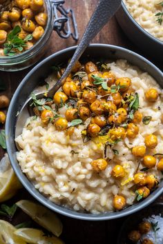 two bowls filled with mashed potatoes and garnished with herbs