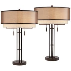 two lamps with beige shades on them