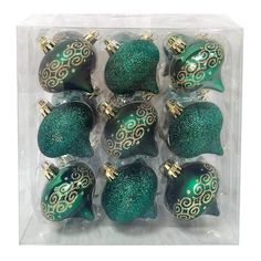 green and gold glass ornaments in a package