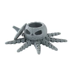 a plastic toy that looks like a spider with two eyes and claws on it's head